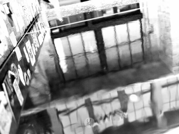 A reflection in a puddle of one of the buildings in Telliskivi.